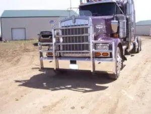 A purple truck is driving down the road.
