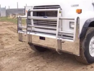 A truck with a large metal fence on the back.